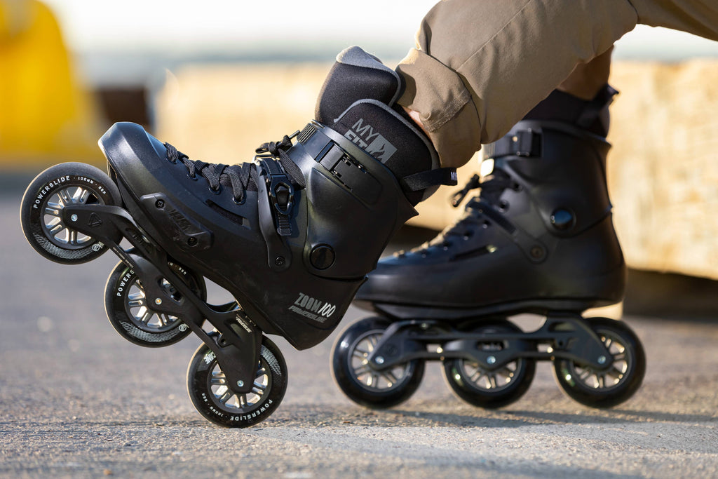 close up of rollerblader with 3 wheel inline skates in his feet