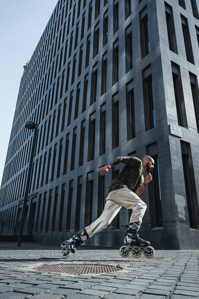 man rollerblading on a street with urban inline skates